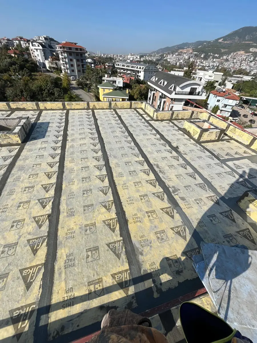 Yüksekten bakışla, sıralar halinde döşenmiş Sika yalıtım levhalarıyla kaplanmış geniş çatı döşemesi
